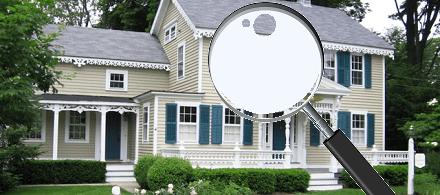 a magnifying glass looking at a house