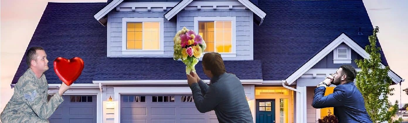 three men kneeling in front of a house, one holding a heart and the other is holding flowers