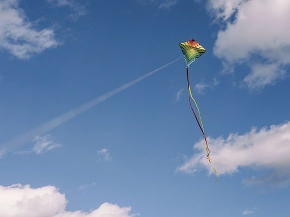 A diamond-shaped kite in flight